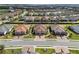 Aerial view of homes with tile roofs, well-manicured lawns, and paver driveways in a beautiful community at 4721 Tortona Ct, Bradenton, FL 34211