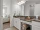 Bathroom with dual sinks, granite countertops, and a view into the bedroom at 4721 Tortona Ct, Bradenton, FL 34211