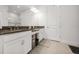Bright bathroom featuring dual sinks with granite countertops and white cabinetry at 4721 Tortona Ct, Bradenton, FL 34211
