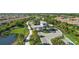 Beautifully landscaped gated community entrance with manicured greenery and sidewalks on a sunny day at 4721 Tortona Ct, Bradenton, FL 34211