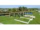 Picturesque view of the Esplanade community entrance with lush landscaping, lake, and palm trees at 4721 Tortona Ct, Bradenton, FL 34211