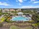 Aerial view of the community pool and lounge area surrounded by lush landscaping and manicured lawns at 4721 Tortona Ct, Bradenton, FL 34211