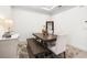 Elegant dining room featuring a modern table with bench seating, neutral decor, and ample natural light at 4721 Tortona Ct, Bradenton, FL 34211