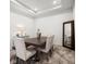 Elegant dining room with a dark wood table, seating for four, and a decorative vase centerpiece at 4721 Tortona Ct, Bradenton, FL 34211