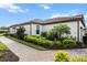 Side view of a well-maintained home with a brick paver walkway and lush landscaping at 4721 Tortona Ct, Bradenton, FL 34211