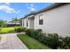 Side view of a well-maintained home with a brick paver walkway and lush landscaping at 4721 Tortona Ct, Bradenton, FL 34211
