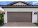 Close-up of a two-car garage with a paver driveway and well-maintained landscaping at 4721 Tortona Ct, Bradenton, FL 34211