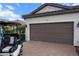Close-up of a two-car garage with a paver driveway and well-maintained landscaping at 4721 Tortona Ct, Bradenton, FL 34211