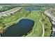 Aerial shot of the golf course, showcasing lush fairways, sparkling ponds and beautiful homes nearby at 4721 Tortona Ct, Bradenton, FL 34211