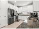 Stylish kitchen with white cabinets, stainless steel appliances, granite countertops, and tile flooring at 4721 Tortona Ct, Bradenton, FL 34211