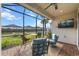 Screened-in lanai with patio furniture overlooks the landscaped backyard at 4721 Tortona Ct, Bradenton, FL 34211