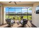 Covered patio with stylish seating offers views of the expansive backyard at 4721 Tortona Ct, Bradenton, FL 34211
