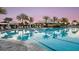 Inviting swimming pool with lounge chairs, palm trees, and shaded cabanas for luxurious relaxation at 4721 Tortona Ct, Bradenton, FL 34211