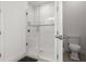 Modern bathroom shower with glass door, white tile, and a built-in bench at 4721 Tortona Ct, Bradenton, FL 34211