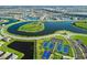 Breathtaking aerial view of the community with a lake, tennis courts, and manicured lawns at 4813 Sparkling Sea Ln, Lakewood Ranch, FL 34211