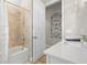 Bathroom featuring shower/tub combo, tiled walls, light countertop and bright lighting at 4813 Sparkling Sea Ln, Lakewood Ranch, FL 34211