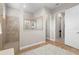 Walk-in shower with glass partition, neutral tile and wood look flooring at 4813 Sparkling Sea Ln, Lakewood Ranch, FL 34211