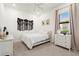 Bright bedroom with a ceiling fan, neutral decor, and large window at 4813 Sparkling Sea Ln, Lakewood Ranch, FL 34211