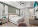 Bright bedroom features a king bed, tray ceiling, and neutral color palette with ample natural light at 4813 Sparkling Sea Ln, Lakewood Ranch, FL 34211