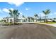 Community center entrance with palm trees, new blacktop, and pretty landscaping at 4813 Sparkling Sea Ln, Lakewood Ranch, FL 34211
