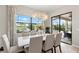 Elegant dining room with large windows overlooking the pool and patio, featuring a modern chandelier at 4813 Sparkling Sea Ln, Lakewood Ranch, FL 34211