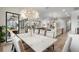 Open dining area with a view of the modern kitchen and adjacent outdoor living space at 4813 Sparkling Sea Ln, Lakewood Ranch, FL 34211