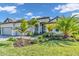 Beautiful single-story home features lush landscaping, well manicured lawn, and a two-car garage at 4813 Sparkling Sea Ln, Lakewood Ranch, FL 34211