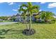 Single-story home featuring a two-car garage and tropical landscaping and curb appeal at 4813 Sparkling Sea Ln, Lakewood Ranch, FL 34211