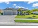 Attractive single-story home showcases a two-car garage, brick driveway, and well-maintained landscaping at 4813 Sparkling Sea Ln, Lakewood Ranch, FL 34211