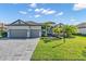 Attractive single-story home showcases a two-car garage, brick driveway, and well-maintained landscaping at 4813 Sparkling Sea Ln, Lakewood Ranch, FL 34211