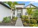 Beautiful home entrance with stone pathway and lush landscaping, creating an inviting curb appeal at 4813 Sparkling Sea Ln, Lakewood Ranch, FL 34211