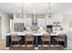 Modern kitchen with an expansive island, stylish pendant lighting, and stainless steel appliances at 4813 Sparkling Sea Ln, Lakewood Ranch, FL 34211