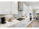 Well-equipped kitchen featuring white cabinets, subway tile backsplash, stainless steel appliances, and gas range at 4813 Sparkling Sea Ln, Lakewood Ranch, FL 34211