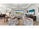 Well-lit living room featuring an open concept design, modern decor, and tile flooring at 4813 Sparkling Sea Ln, Lakewood Ranch, FL 34211