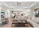 Bright and airy living room with ample seating, stylish decor, and an open layout to the kitchen at 4813 Sparkling Sea Ln, Lakewood Ranch, FL 34211