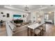 Open living space with stylish furnishings, a mounted television, and an adjacent kitchen area at 4813 Sparkling Sea Ln, Lakewood Ranch, FL 34211