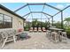 Screened-in pool area featuring outdoor seating, a fire pit, a grill, and a bar area at 4813 Sparkling Sea Ln, Lakewood Ranch, FL 34211