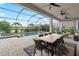 Screened-in pool area featuring a spa, outdoor dining, ceiling fans, and beautiful outdoor furniture at 4813 Sparkling Sea Ln, Lakewood Ranch, FL 34211