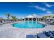 Large community pool with lounge chairs and covered seating area under a bright blue sky at 4813 Sparkling Sea Ln, Lakewood Ranch, FL 34211