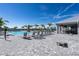 Resort-style pool area with lounge chairs, palm trees, and a covered pavilion at 4813 Sparkling Sea Ln, Lakewood Ranch, FL 34211