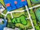 Aerial shot showing a basketball court, putting green, and walkways in a landscaped community space at 4813 Sparkling Sea Ln, Lakewood Ranch, FL 34211