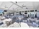 Spacious restaurant with ceiling fans, tables and chairs, TVs, full bar, patio access, and fireplace at 4813 Sparkling Sea Ln, Lakewood Ranch, FL 34211