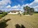 View of the home's well-maintained backyard with tropical landscaping and healthy green grass at 503 Philodendron, Punta Gorda, FL 33955