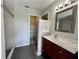 Bathroom featuring a cherry vanity, framed mirror, and a shower with tile surround at 503 Philodendron, Punta Gorda, FL 33955