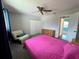 Bedroom featuring a ceiling fan, plush recliner, and view to the front door at 503 Philodendron, Punta Gorda, FL 33955