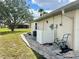 Exterior view of the home with access door, AC unit, and garden hose reel at 503 Philodendron, Punta Gorda, FL 33955