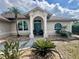 Inviting front entrance with decorative pillars and lush landscaping at 503 Philodendron, Punta Gorda, FL 33955