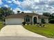 Charming single-story home with a well-manicured lawn, lush landscaping, and a spacious two-car garage at 503 Philodendron, Punta Gorda, FL 33955