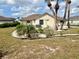 A wide open front yard with lawn decor and palms in the Florida sun at 503 Philodendron, Punta Gorda, FL 33955