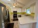 Bright kitchen with stainless steel appliances and white cabinetry at 503 Philodendron, Punta Gorda, FL 33955